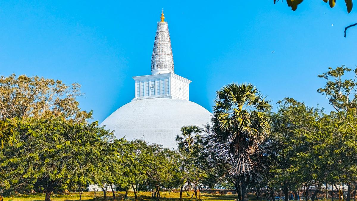 White stupa among trees in Anuradhapura